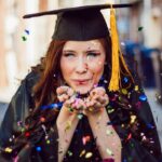 woman blowing assorted color confettis