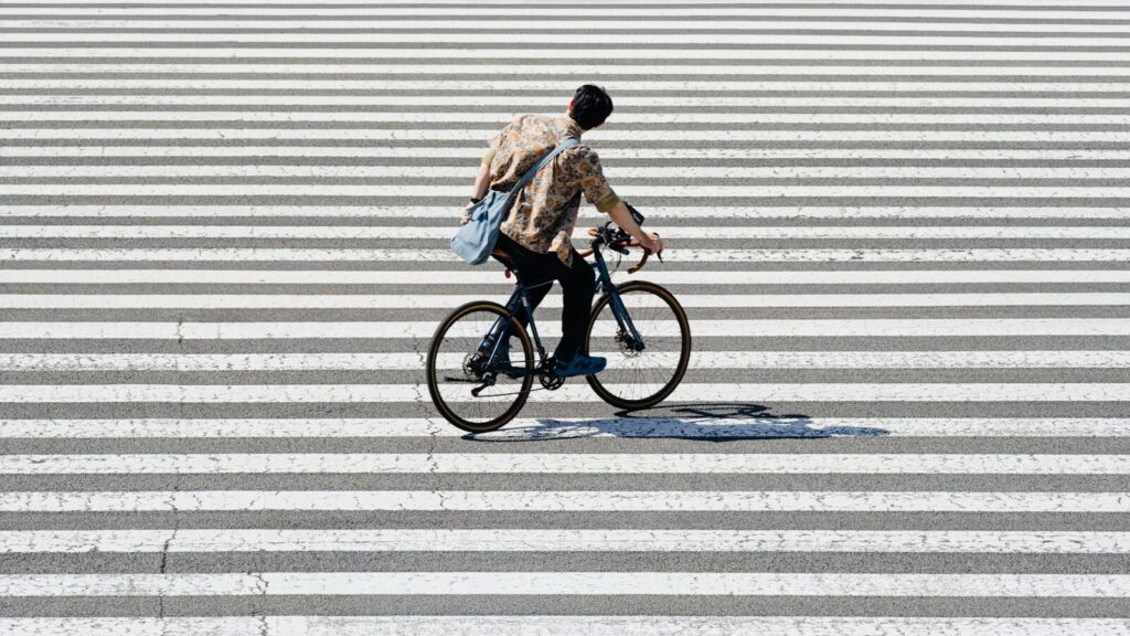 Person riding a bicycle on a crosswalk