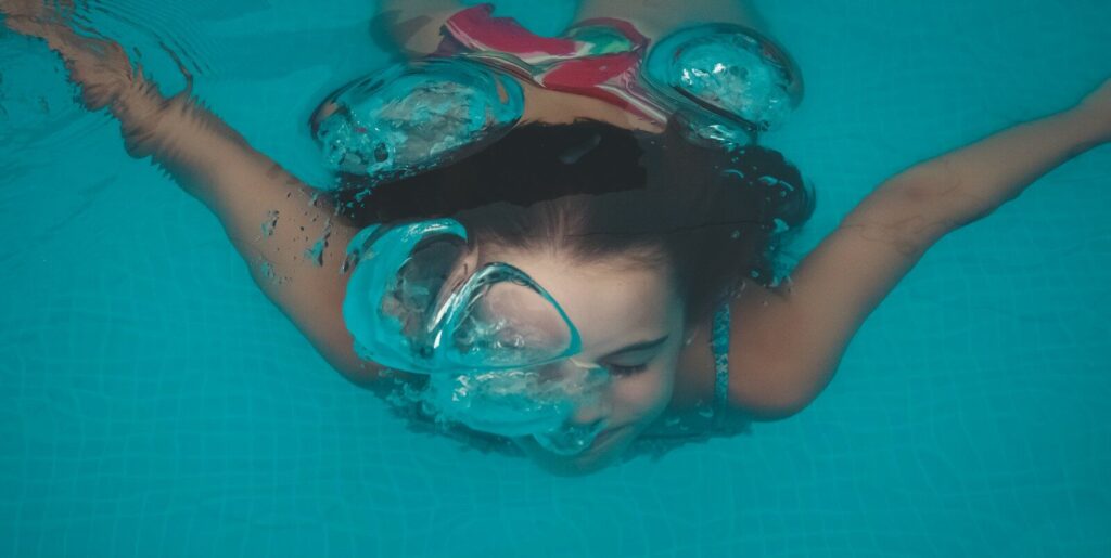 woman swimming under water