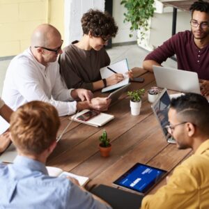 A group of professionals having a meeting in a modern office environment, fostering teamwork and brainstorming.