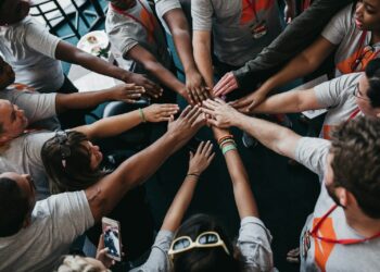 people with hands gathered in the middle
